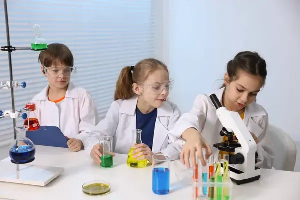 depositphotos_810583514-stock-photo-children-doing-chemical-experiment-desk
